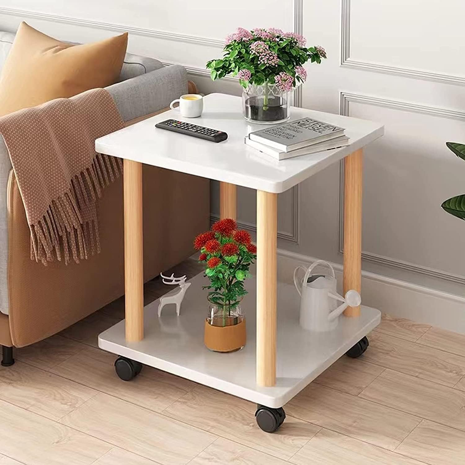 A Rolling Side Table with Storage Shelf is Kept on the Side Of Sofa.