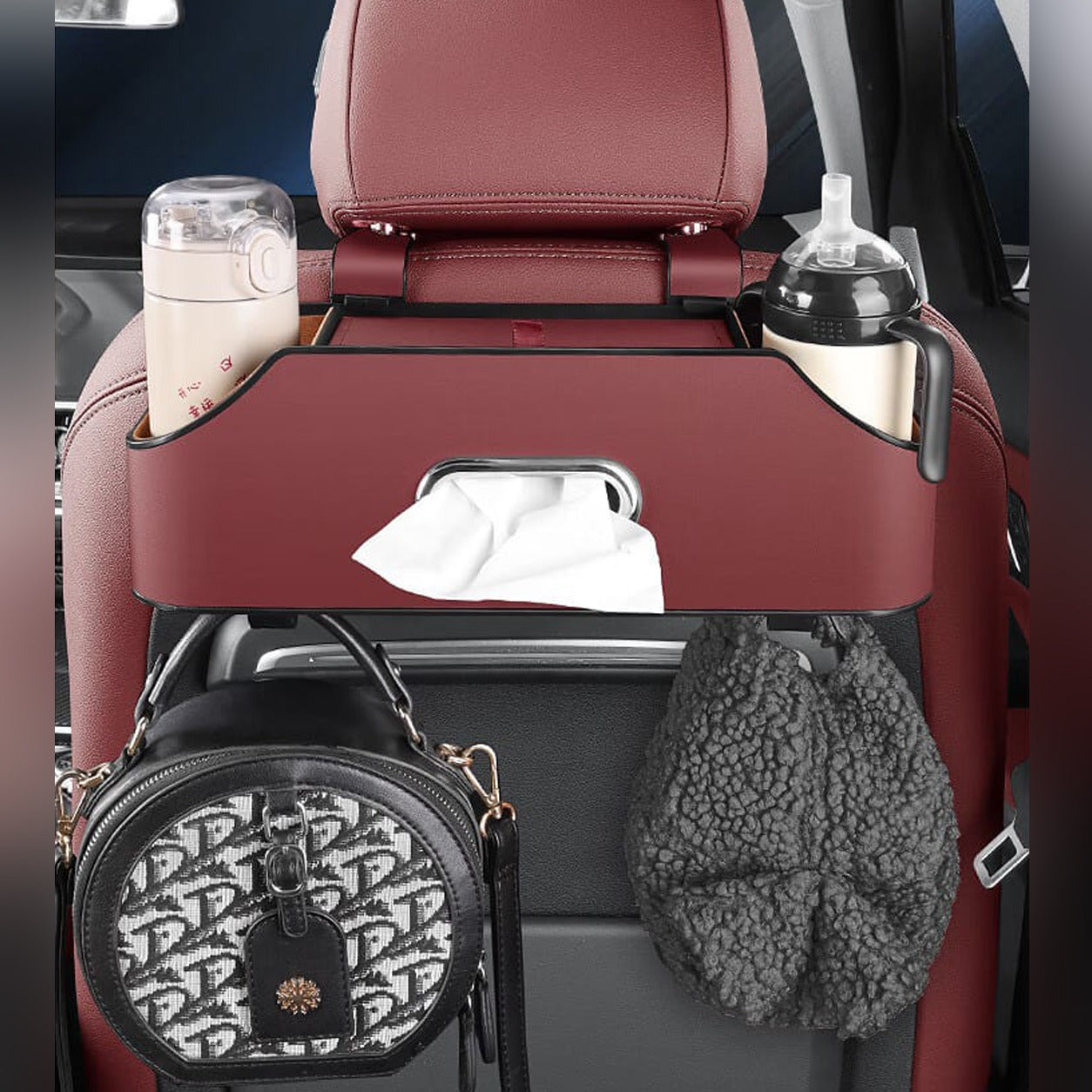 Car Seat Headrest Storage Organizer Box With Tissues and Bottles Organized in it.