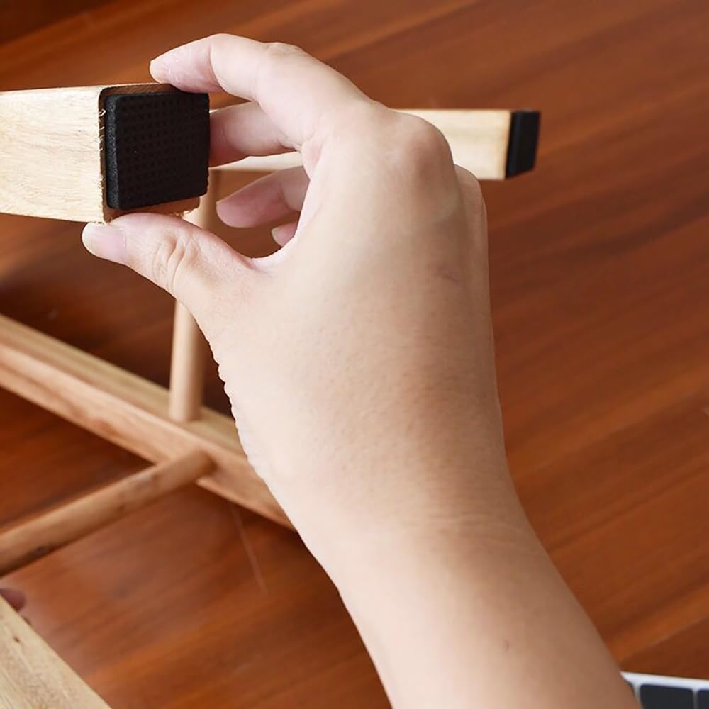 Hand fixing a Self-Adhesive Furniture Pads on chair.