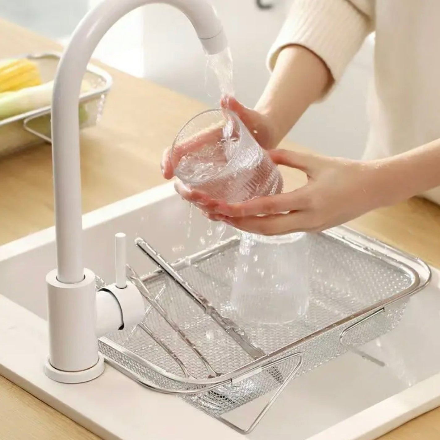 A Person is Washing Utensils By Placing Sink Drain Basket Colander Over the Sink.