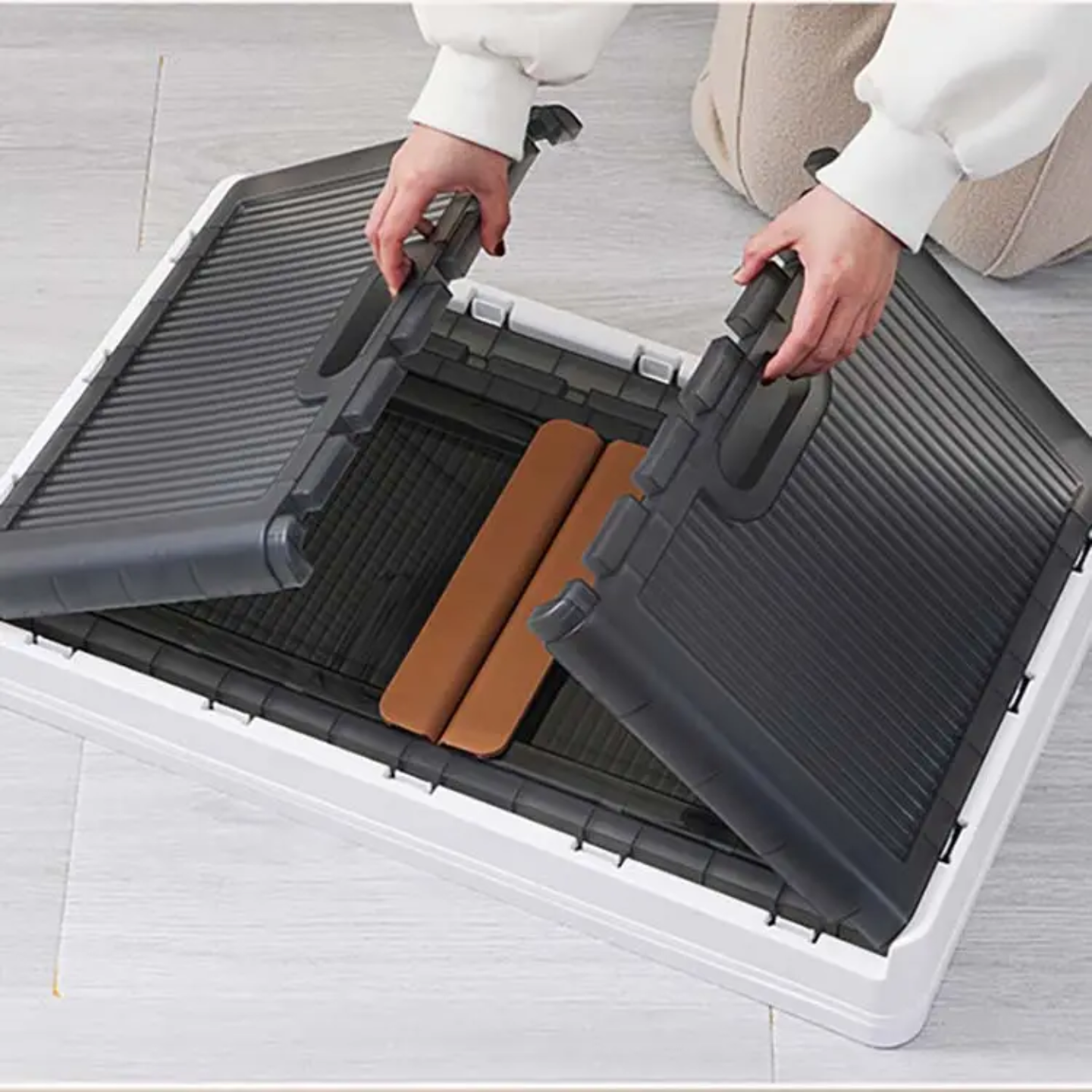 A Person is Setting Stackable Storage Bins.