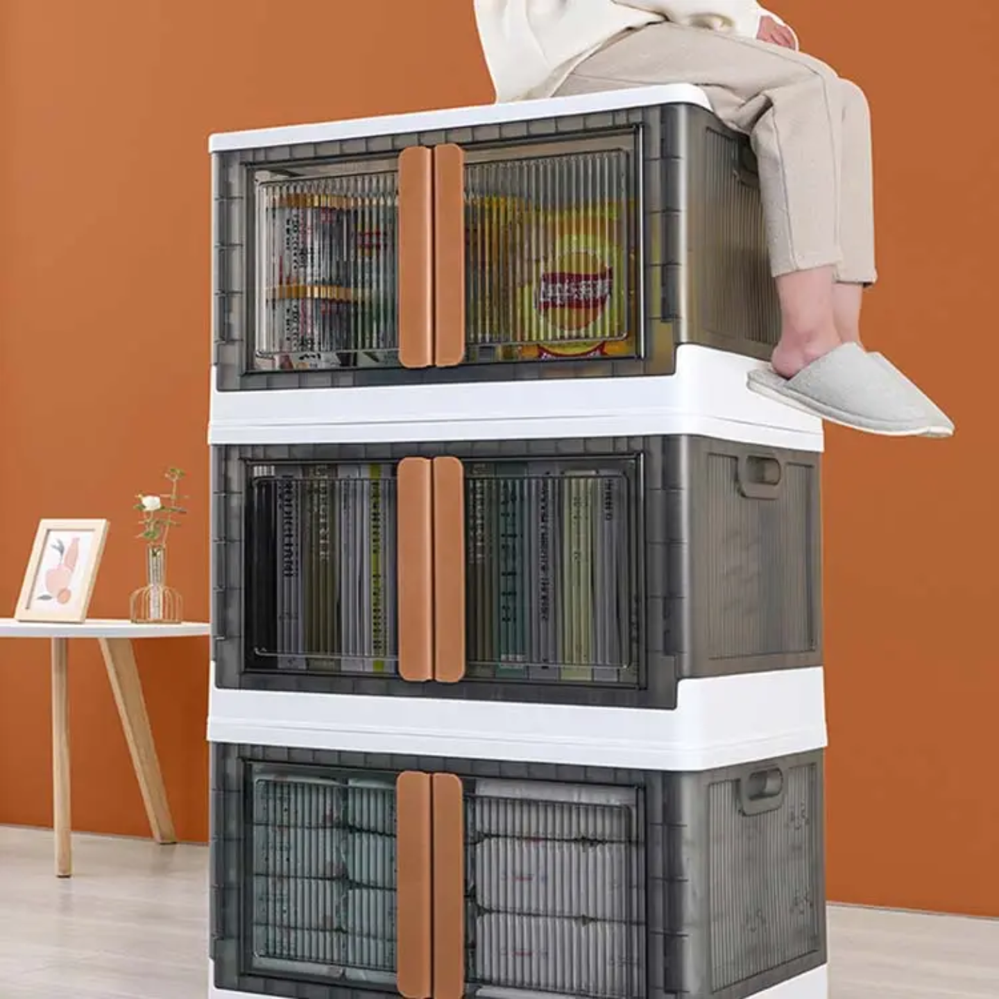 A Person is Sitting On a Stackable Storage Bins.