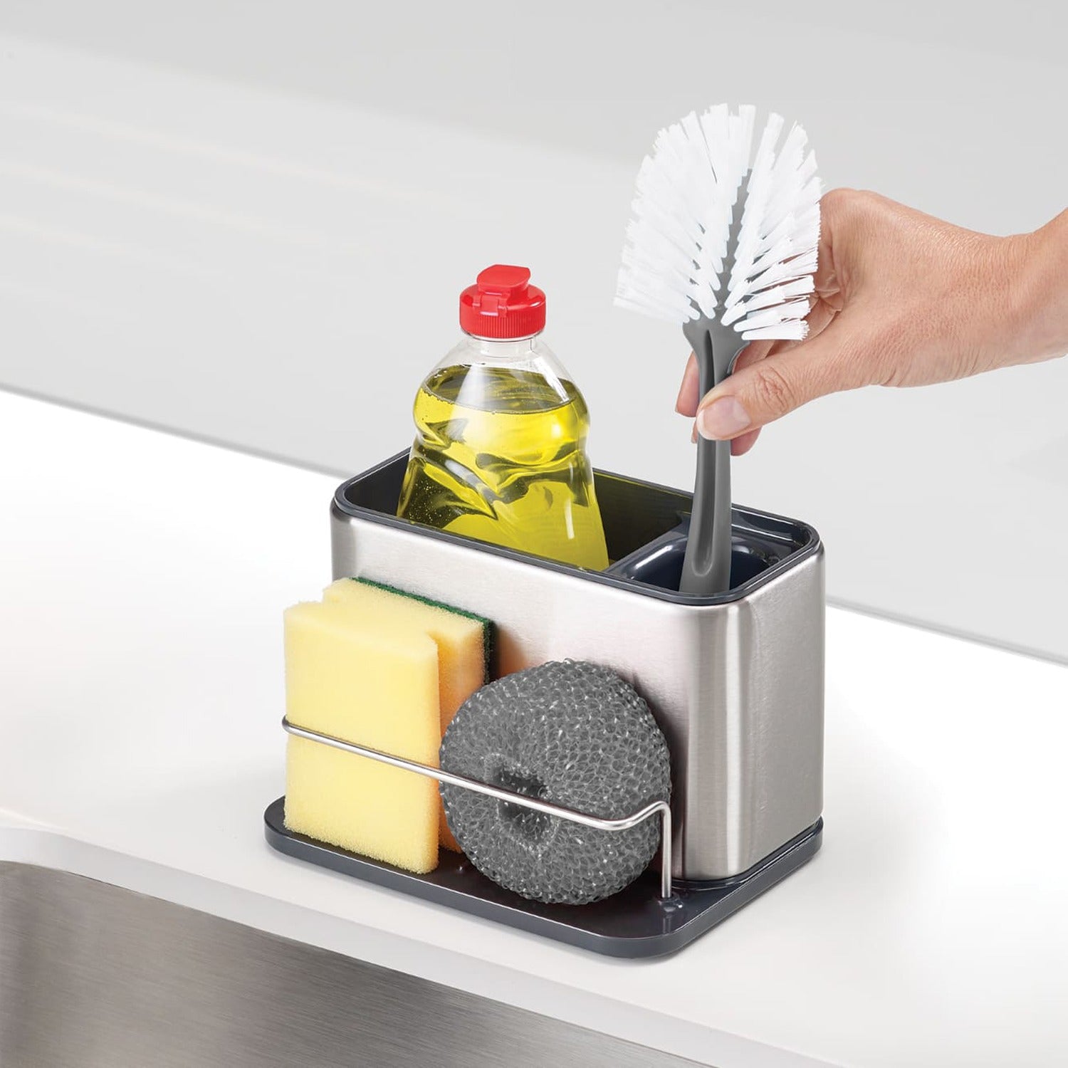 A Person is Taking Brush From Stainless Steel Sink Organizer Rack.