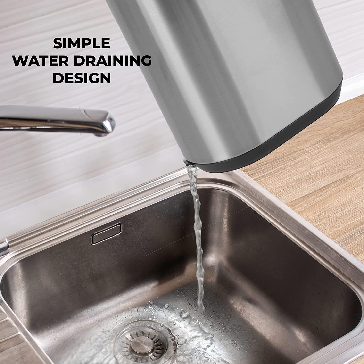 A stainless steel sink storage rack is shown tilted over a kitchen sink, allowing water to drain easily from its base.