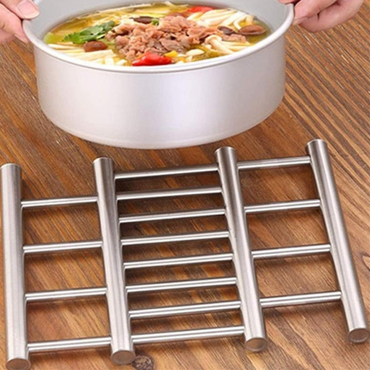 A Person is Keeping Food Container On Stainless Steel Trivet Pot Pad.
