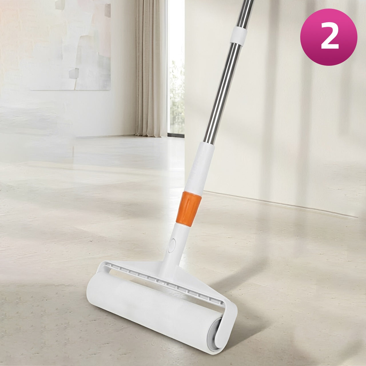 A Sticky Mop with an orange accent on the handle, shown on a light-colored floor in a bright room. A pink circular badge with the number 2 is in the top right corner.