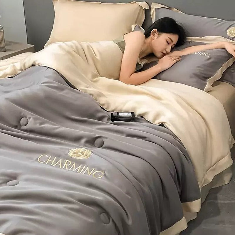 A Woman is Sleeping on Summer Quilted Cooling Comforter Bedding Set.