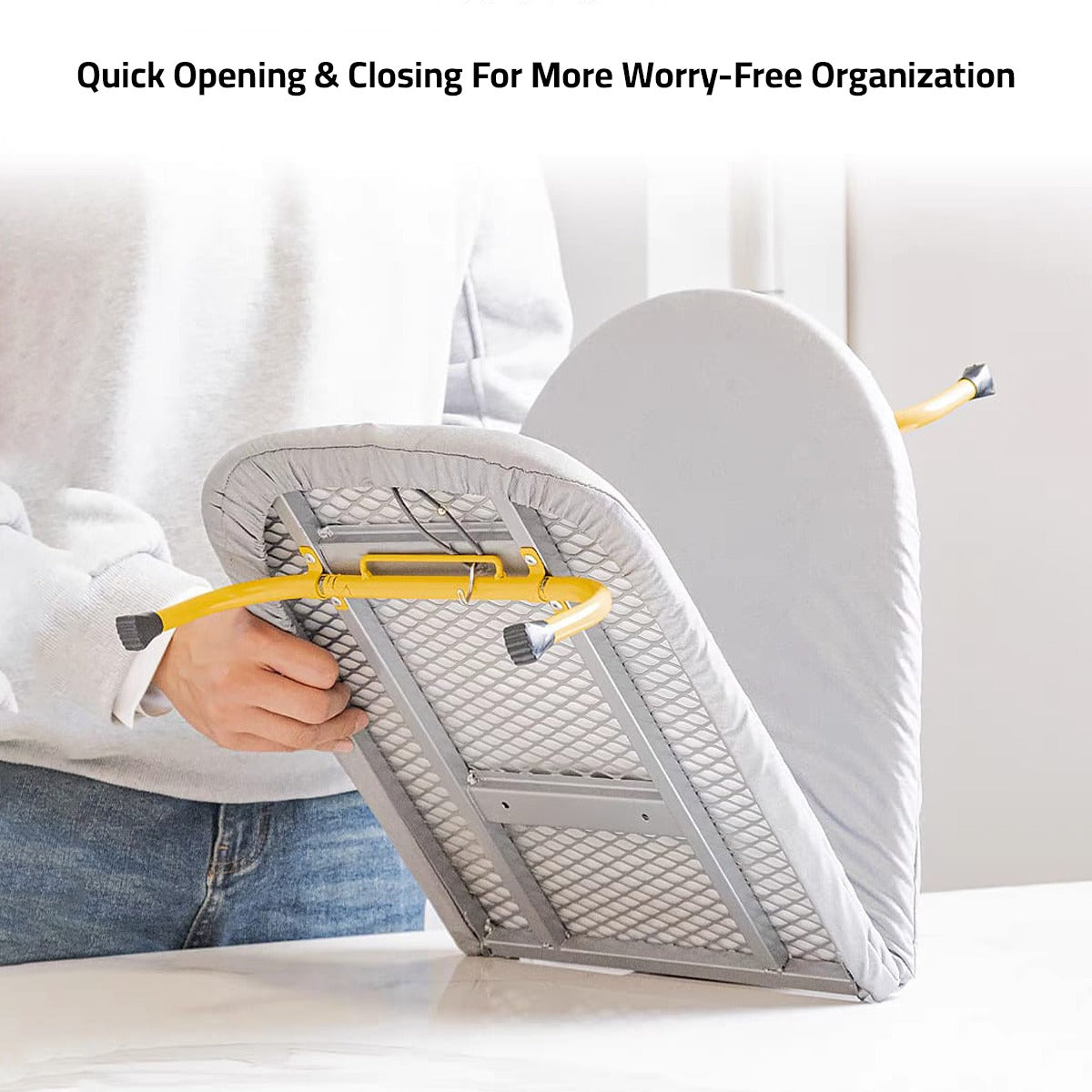 A Person is Folding Tabletop Foldable Ironing Board With Iron Holder.