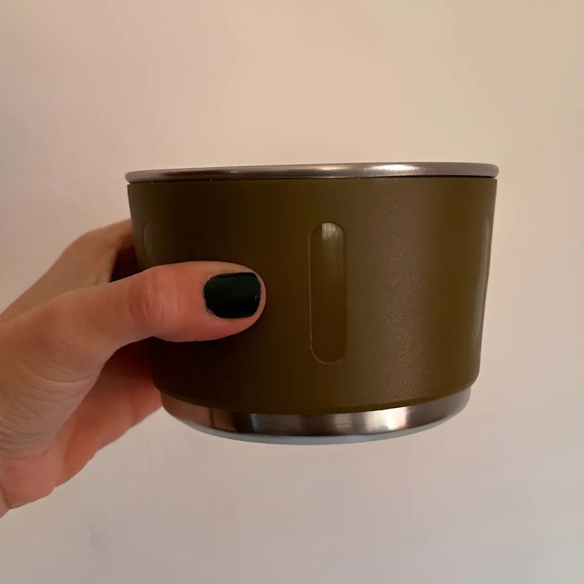 A Person is Holding the Lid Of Thermal Insulated Travel Flask.