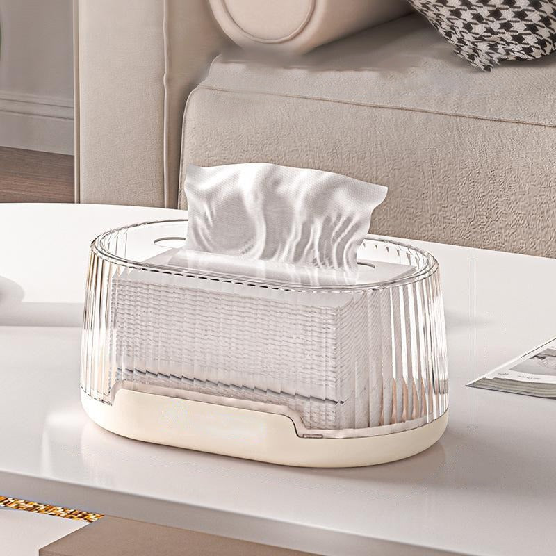 Transparent cream Oval tissue box placed on a table ,with one tissue pulled up