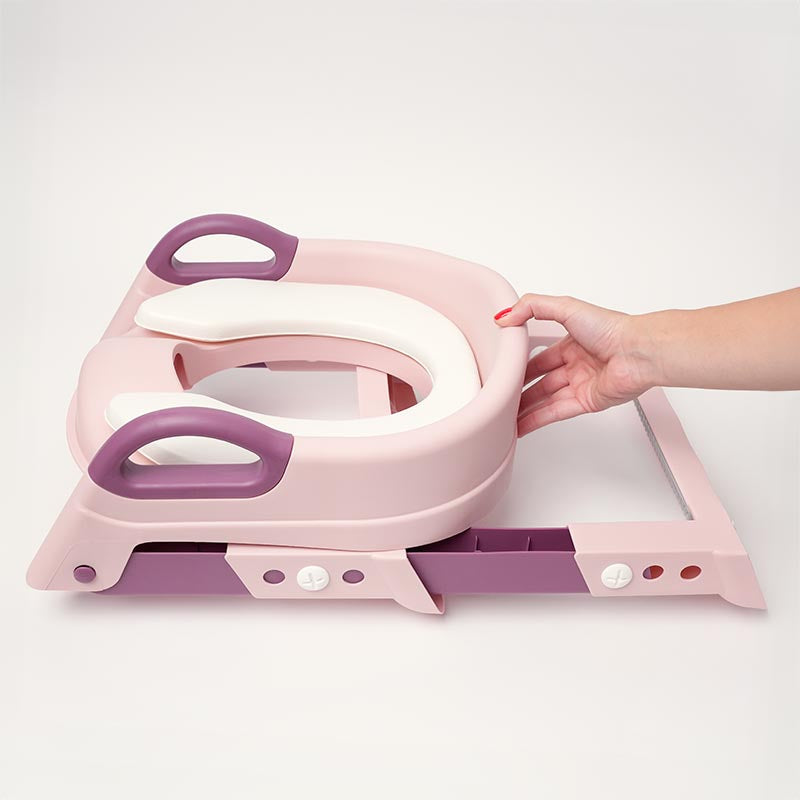 Pink and purple step stool with a hand lifting one of its steps.