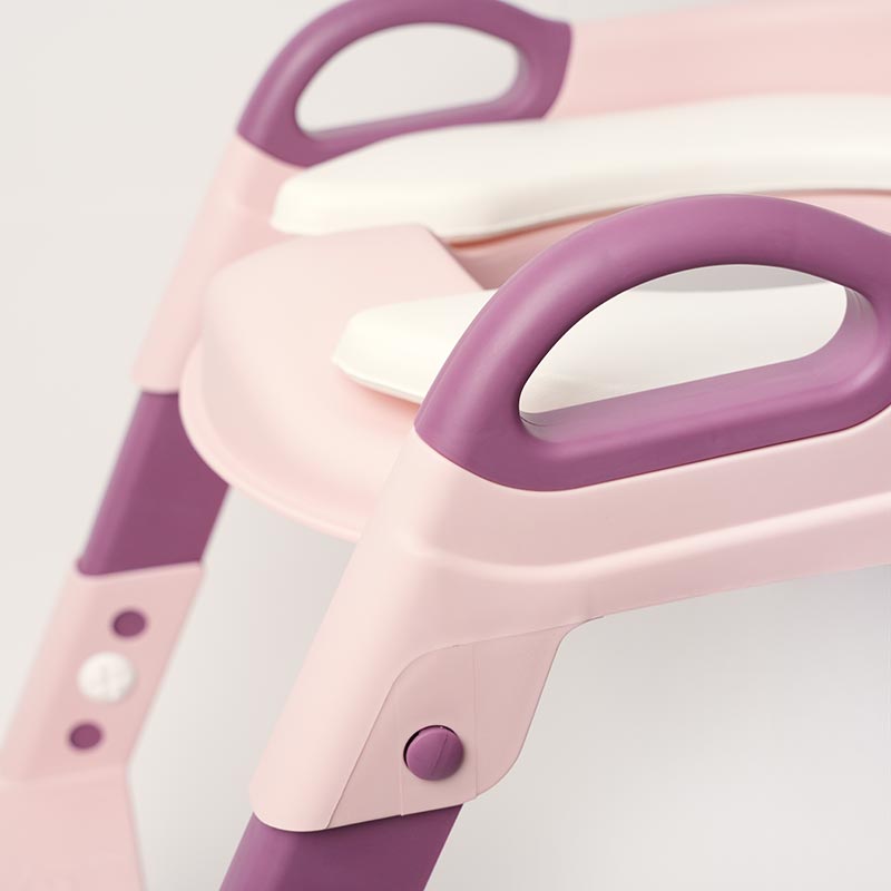 Pink and purple children's potty chair on a light gray background.