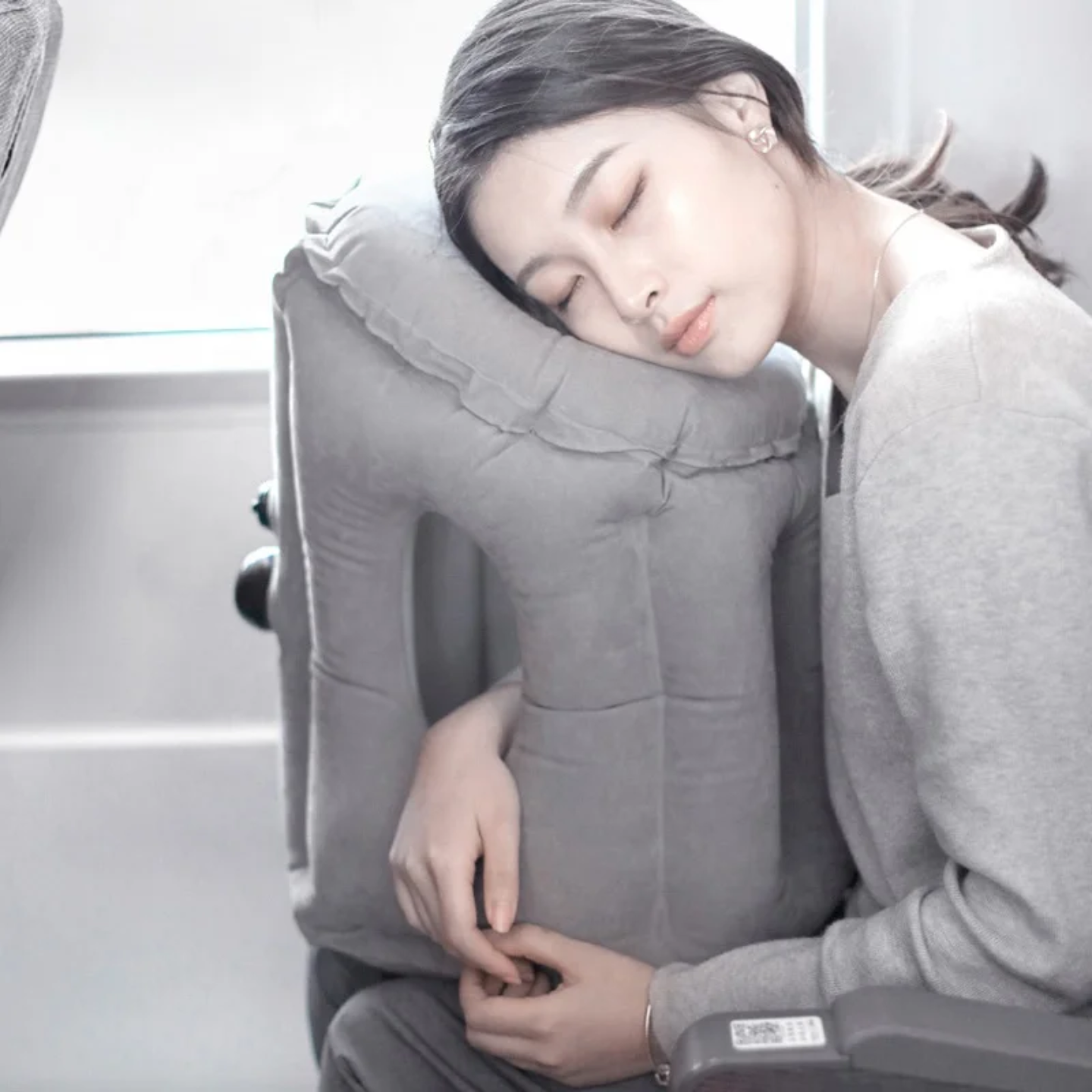 A Woman is Sleeping with the aid Of Travel Neck Pillow.
