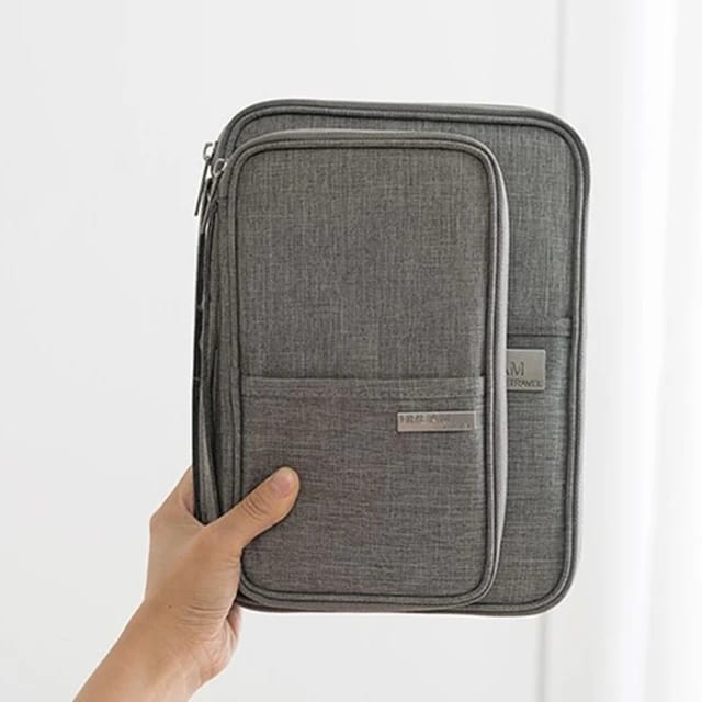 Someone confidently holding the Travel Passport and Document Organizer Bag with one hand