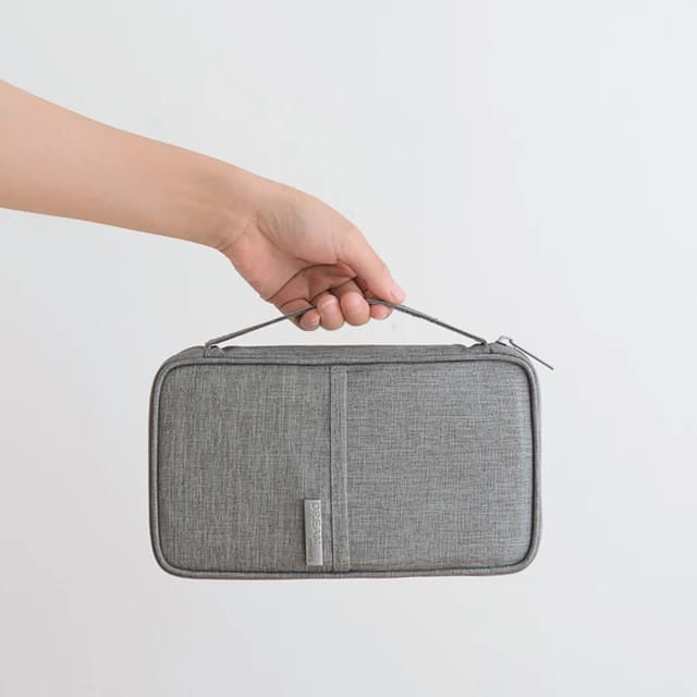 Someone confidently holding the Travel Passport and Document Organizer Bag with one hand