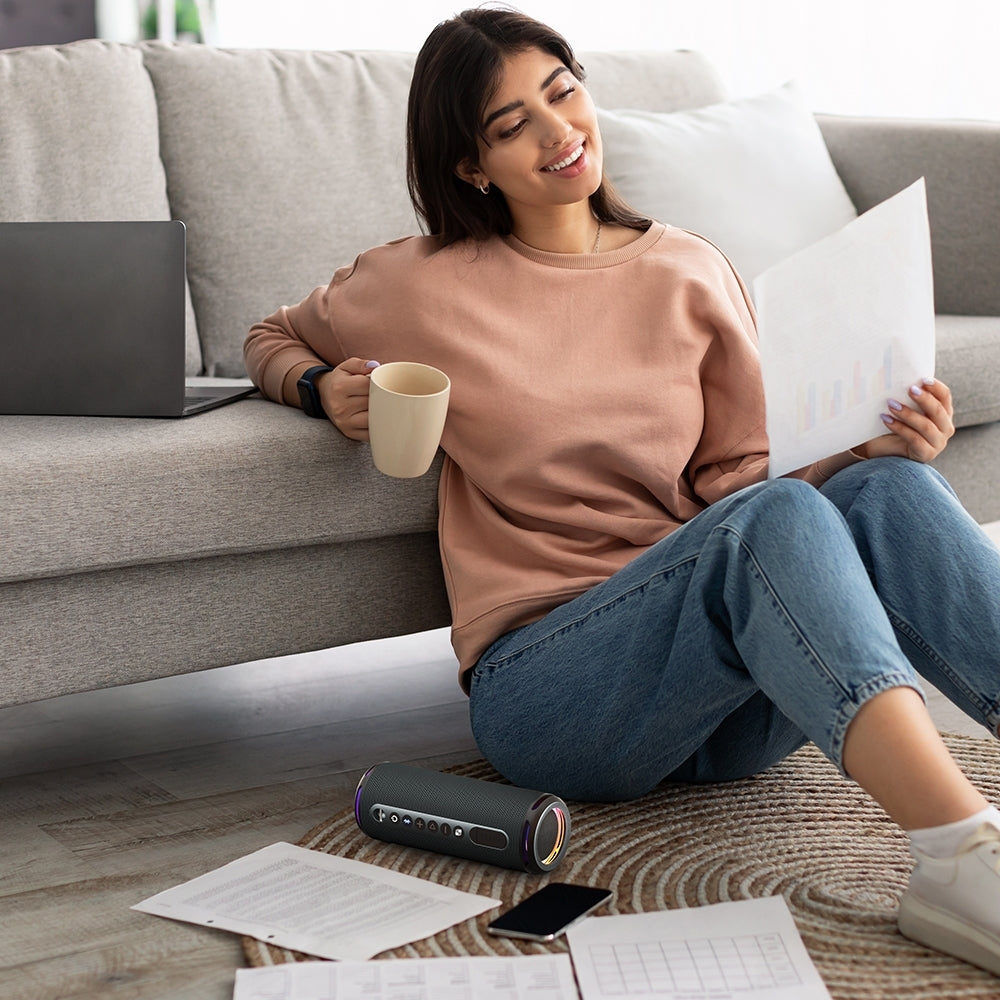 A Women Enjoying With Tronsmart T7 Lite Portable Outdoor Speaker While Working.