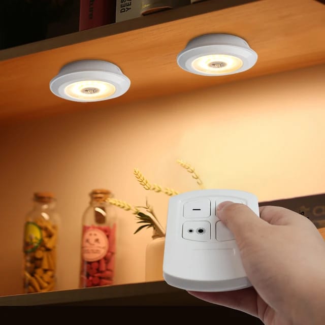 A Person is Turning On 3 Pcs Dimmable LED Under Cabinet Light Using Remote Control.