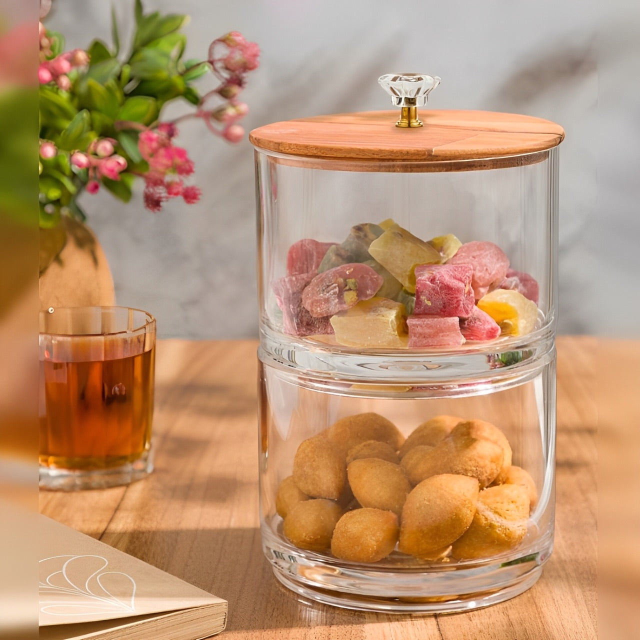 A Two Layer Candy Jar with Wooden Lid Filled with Dried Fruits.