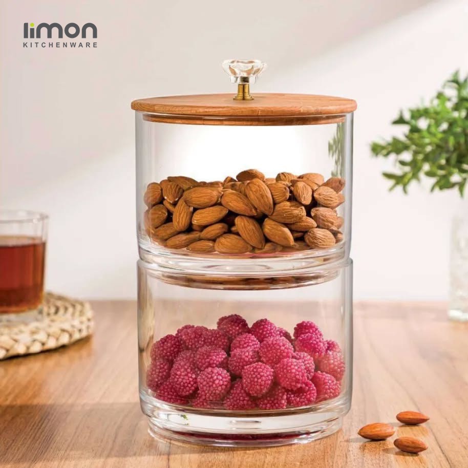 A Two Layer Candy Jar with Wooden Lid Filled with Nuts.