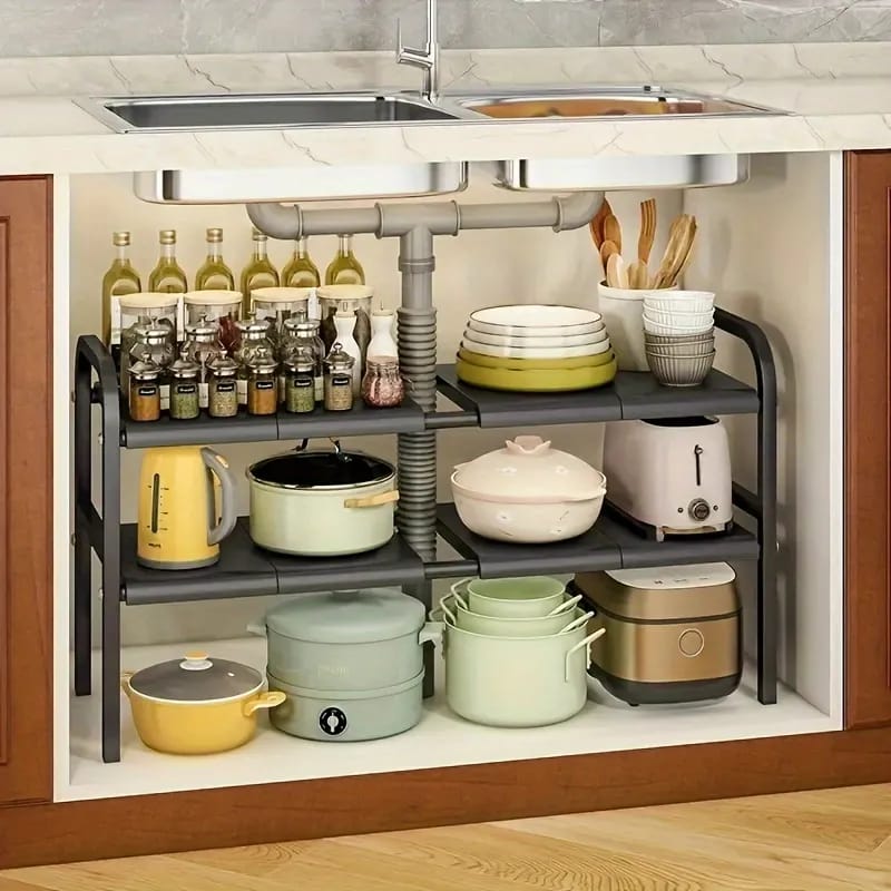 Under Sink Storage Rack is Placed Under Kitchen Sink Organized With Kitchen Items.