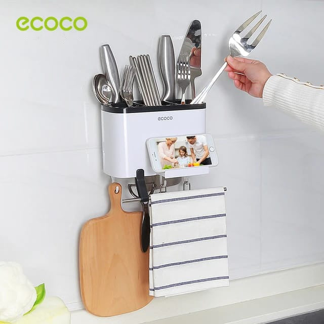 Someone placing something into the Ecoco Utensil Storage Rack