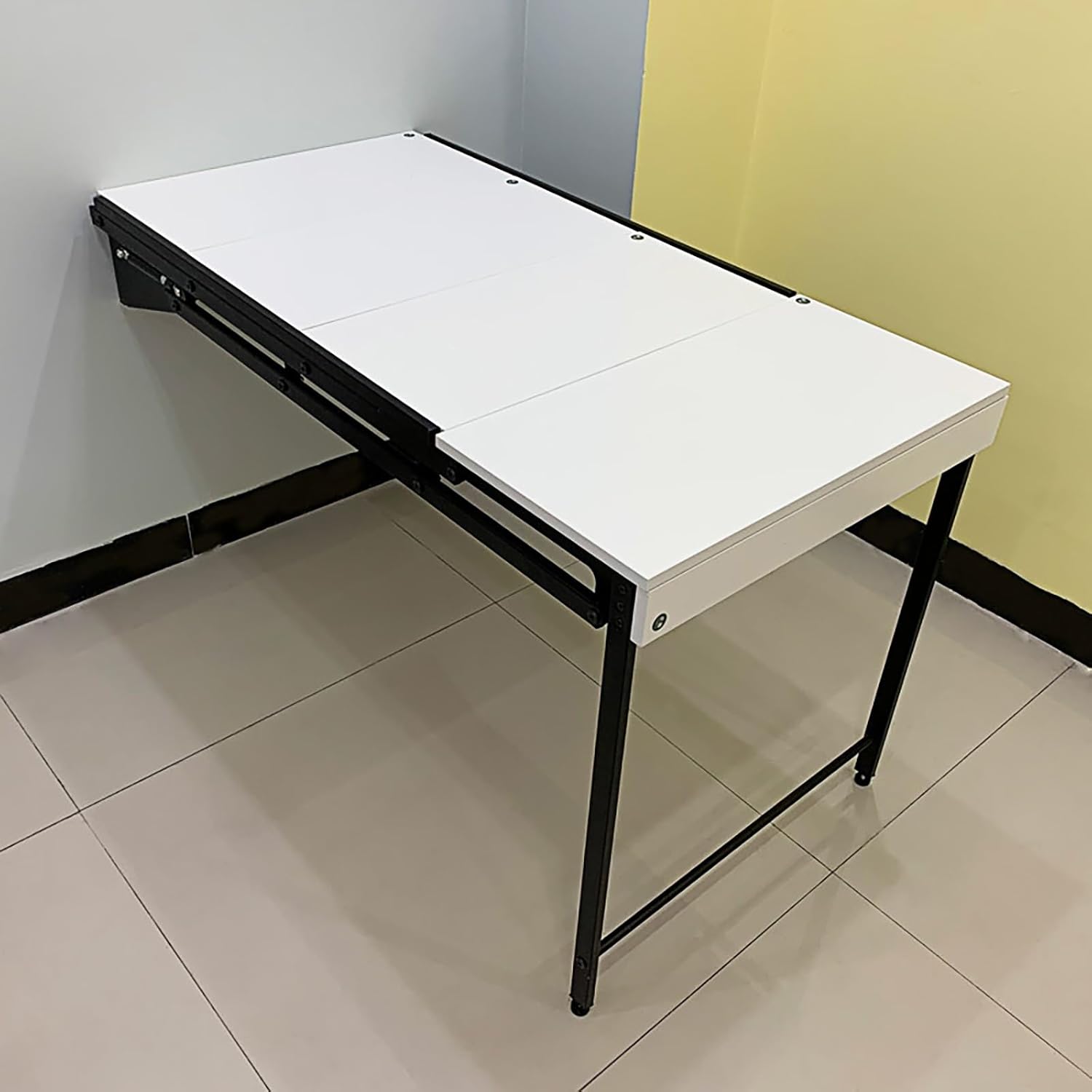 A Wall Mounted Folding Table is Attached to a Wall.