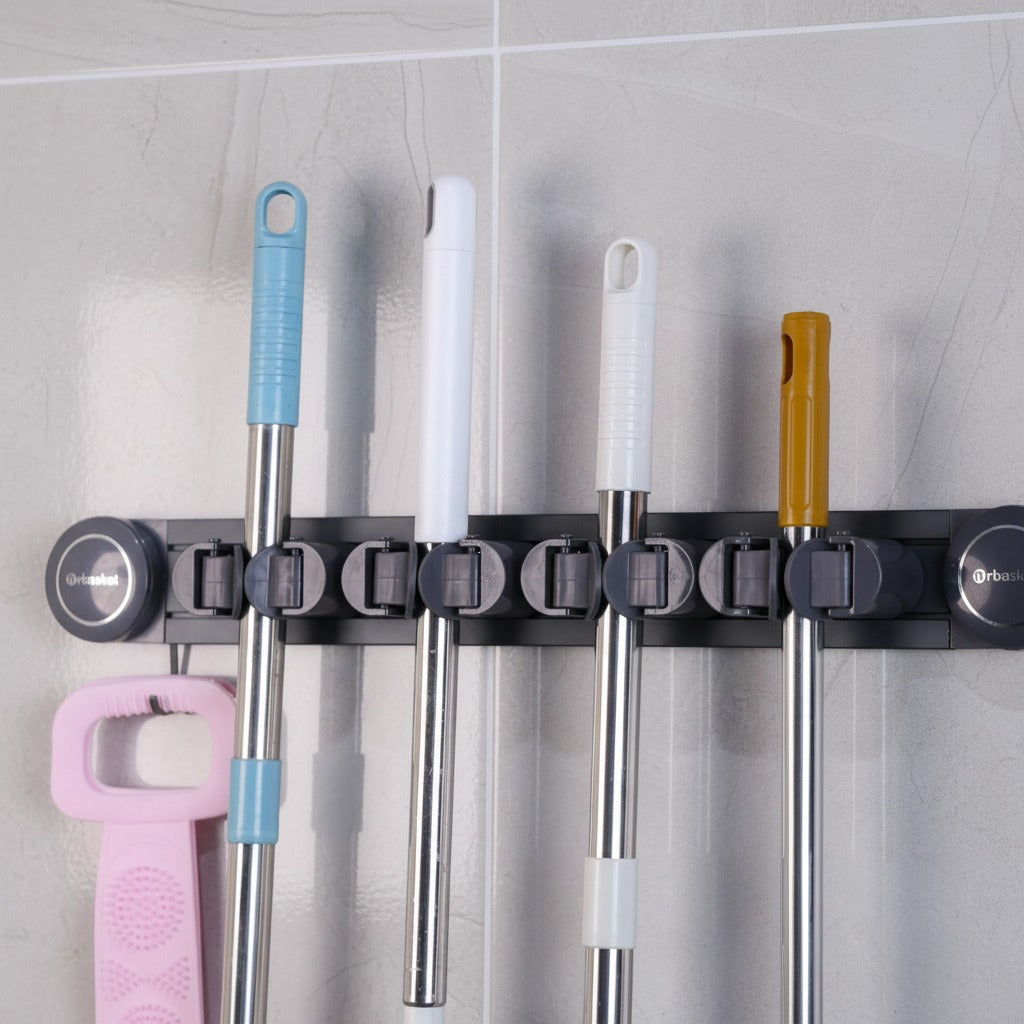 Mops and Brooms are Organized in a Wall Mounted Mop Holder.