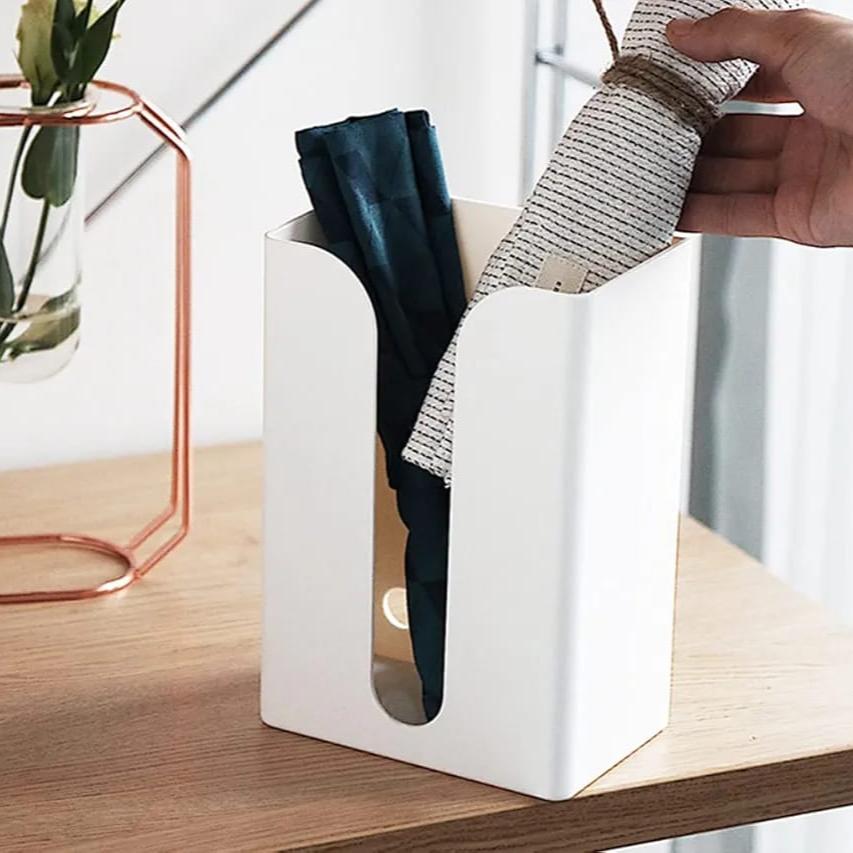 A Person is Keeping Towel On Wall Mounted Tissue Box Holder Dispenser Rack.