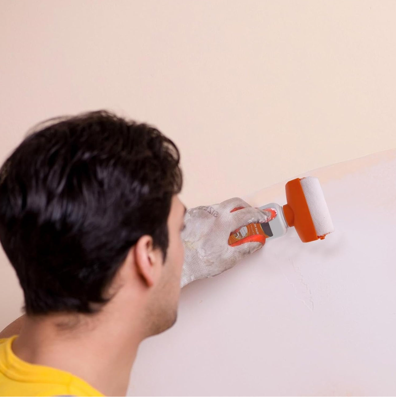 A Man is Repairing the Wall Using Wall Repair Paint Roller Kit.