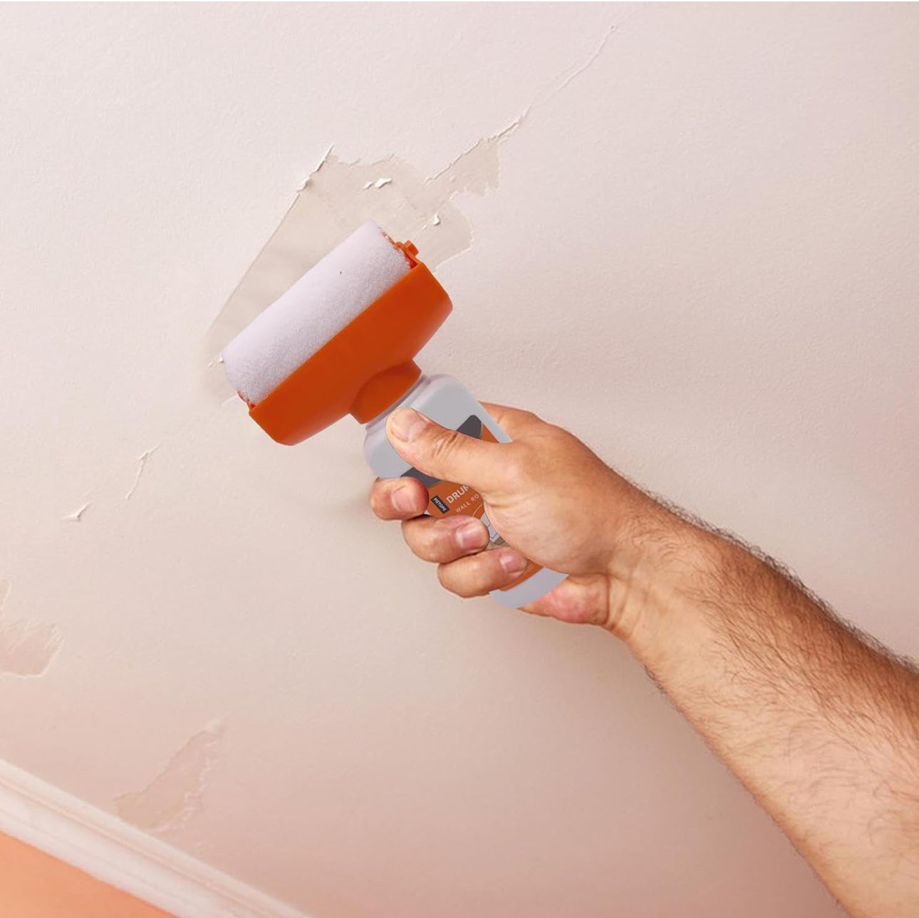 A Person is Repairing Wall Using Wall Repair Paint Roller Kit.