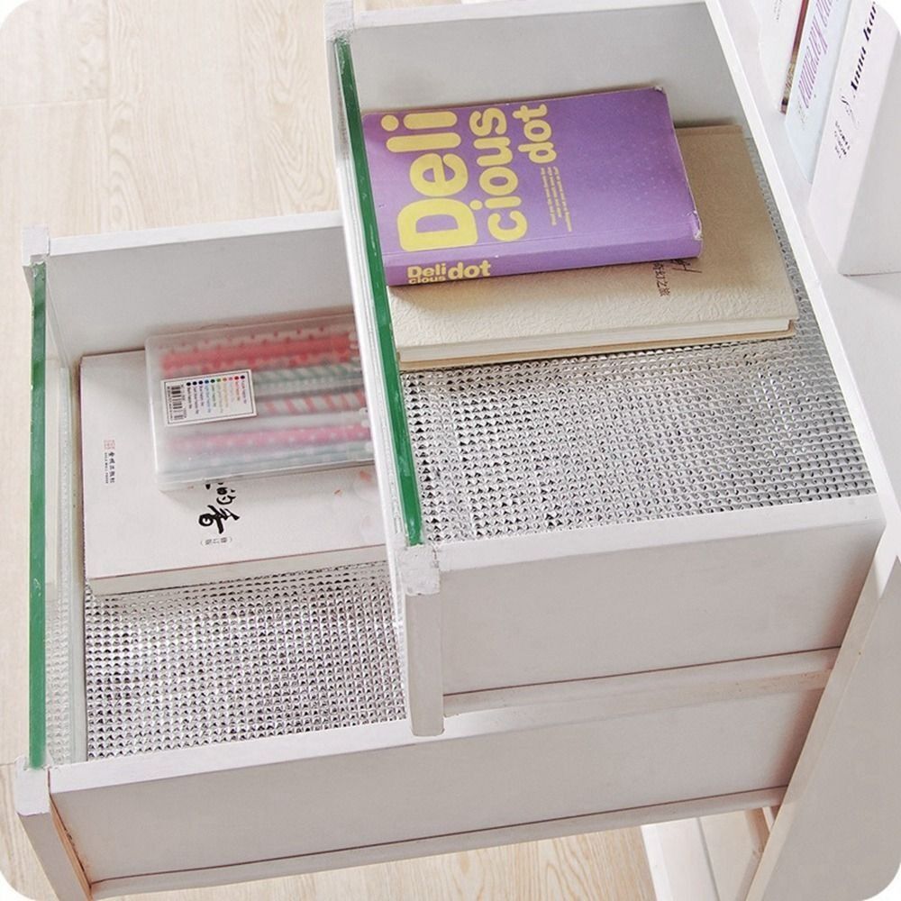 A Waterproof Anti-Slip Cabinet & Wardrobe Sheet placed inside a drawer, neatly holding everyday items