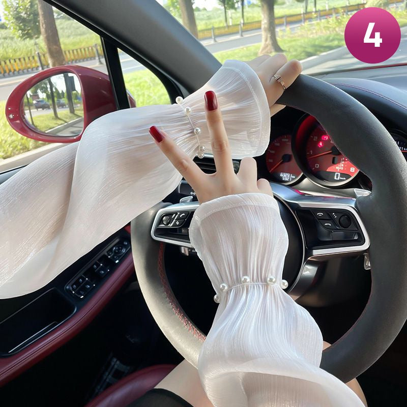 A Women is Wearing Women Summer Arm Sleeves While Driving.