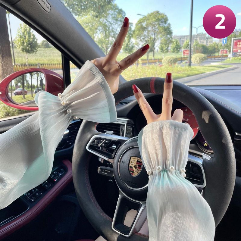 A Women is Wearing Women Summer Arm Sleeves While Driving.