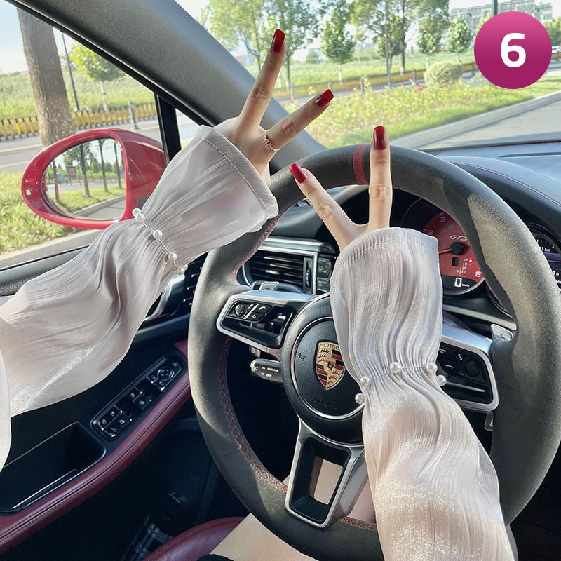 A Women is Wearing Women Summer Arm Sleeves While Driving.