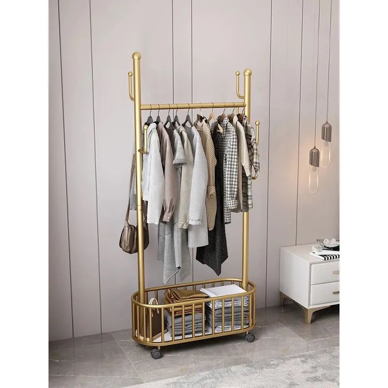 A Classic Minimalist Modern Metal Clothing Stand Wardrobe Garment Storage Rack with wheels is placed on the floor, adorned with dresses and bags