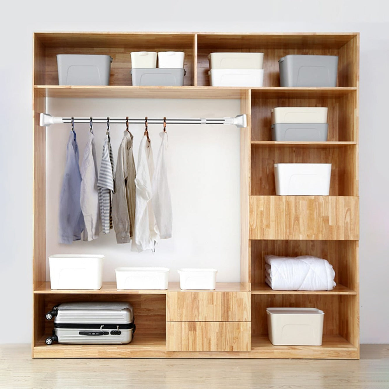 Shirts hung on Adjustable Drill-Free Rod installed in a cupboard