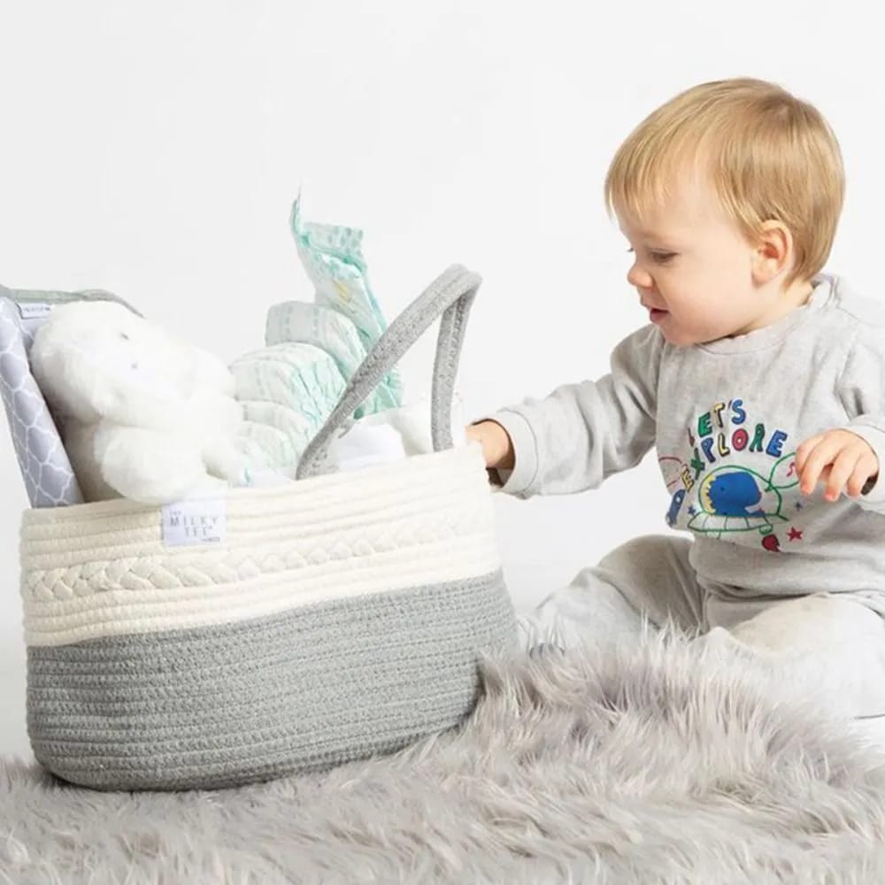 A baby holding a well organized Nursery Storage Basket