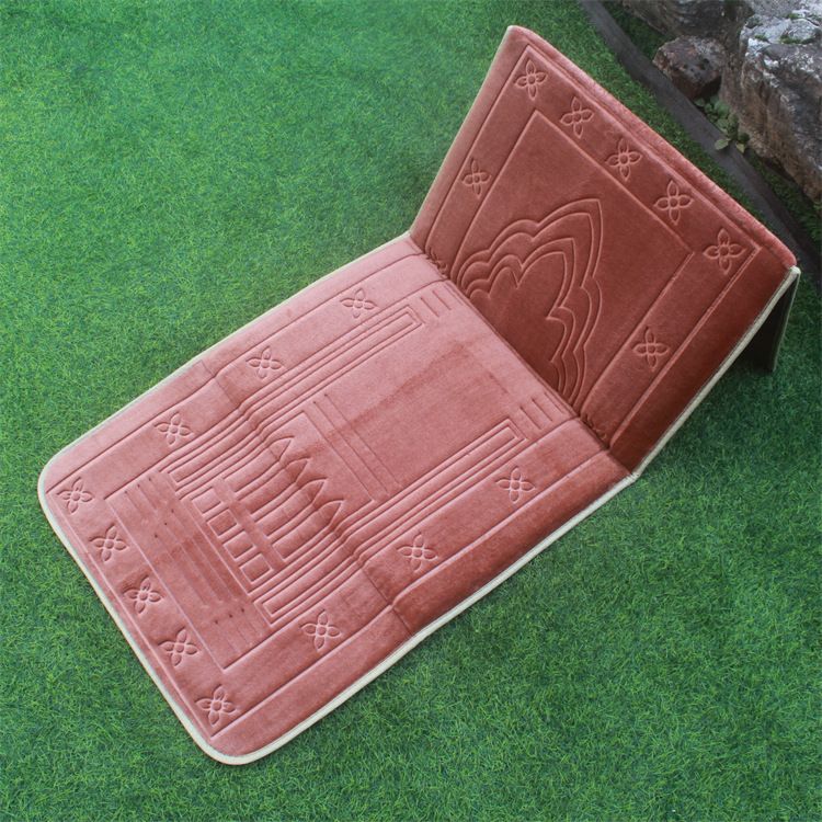 Brown color Islamic Foldable Prayer Mat placed on a grass with backrest opened