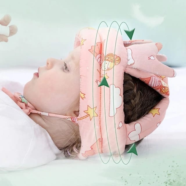 A baby lying on a white surface wearing Baby Walking Cap