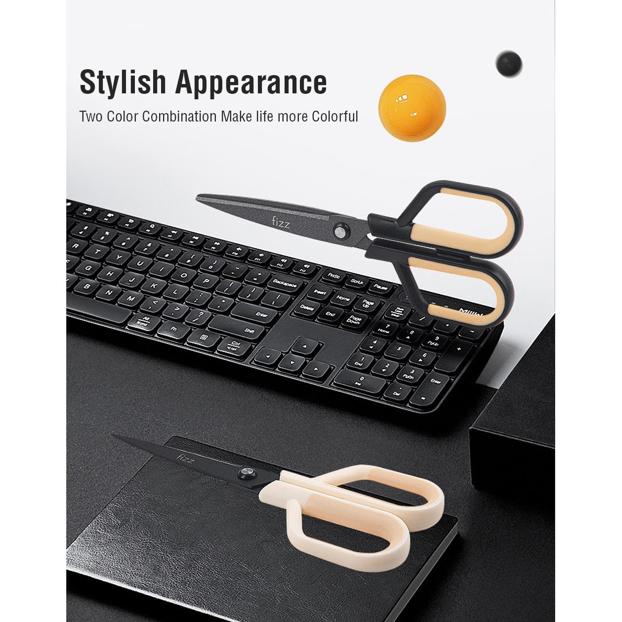 Showcasing the stylish appearance of 2 Scissors with Paper Cutting Blade placed on top of a keyboard and a book