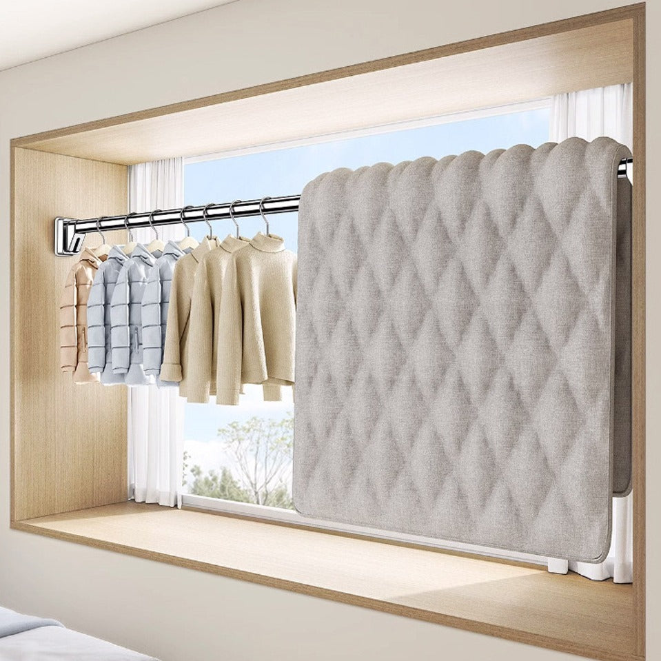 Cloths and a blanket hung on Extendable Tension Rod mounted on a window frame