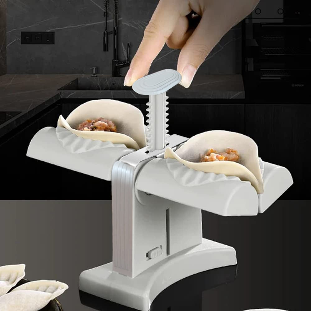 Someone making dumplings with the help of Double Head Semi Automatic Dumpling Maker Mould