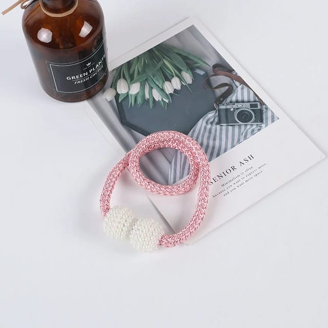 Showcasing Pink Color Magnetic Curtain Binding Rope placed on top of table