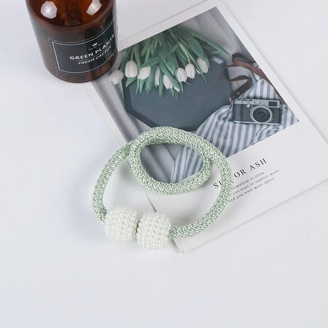 Showcasing Green Color Magnetic Curtain Binding Rope placed on top of table