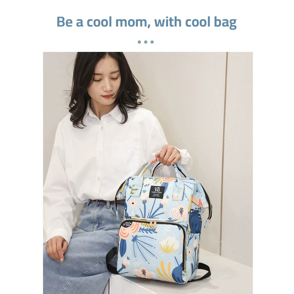 A woman holding a Mother Backpack Bag