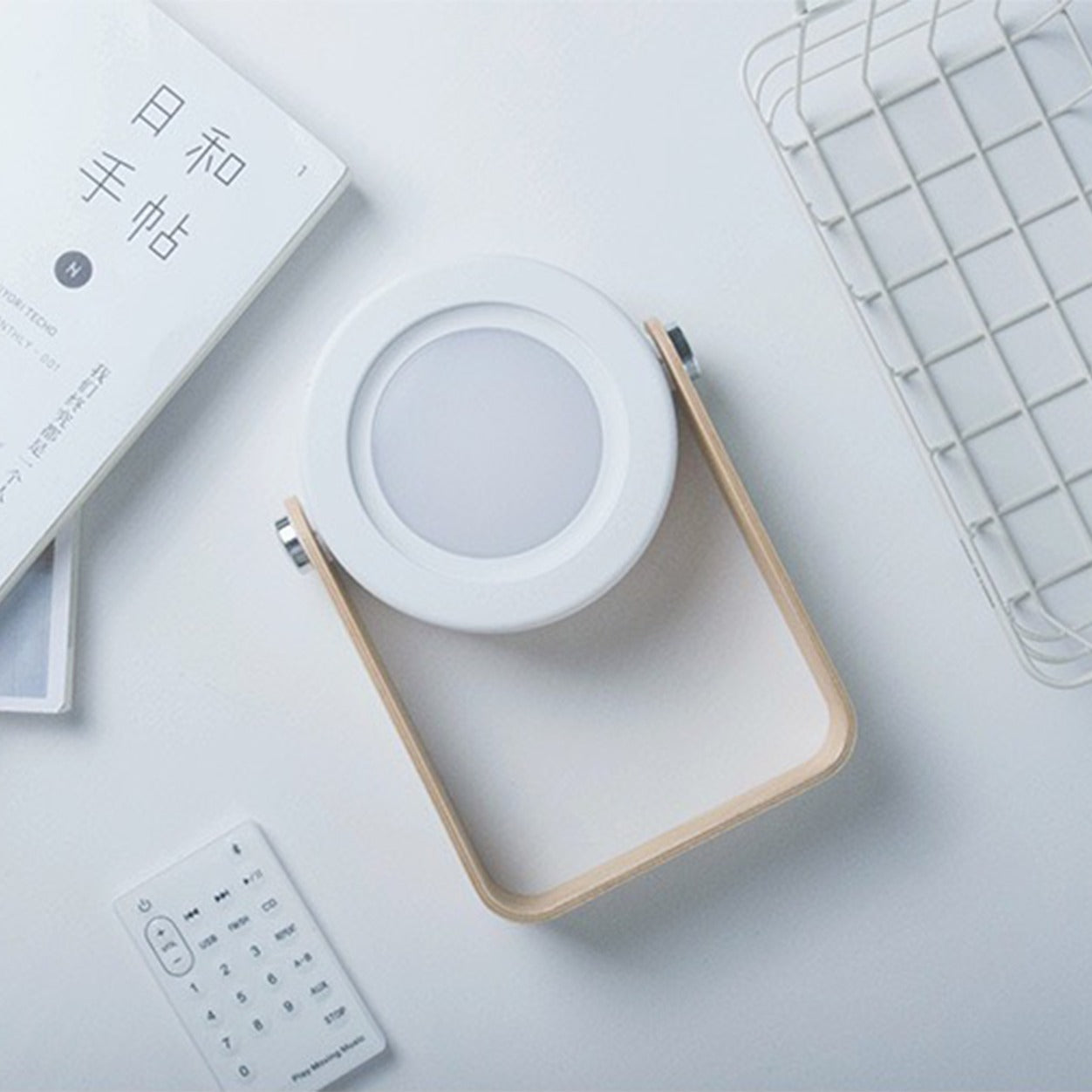 Retractable Table Lamp with USB Rechargeable on a table next to some items