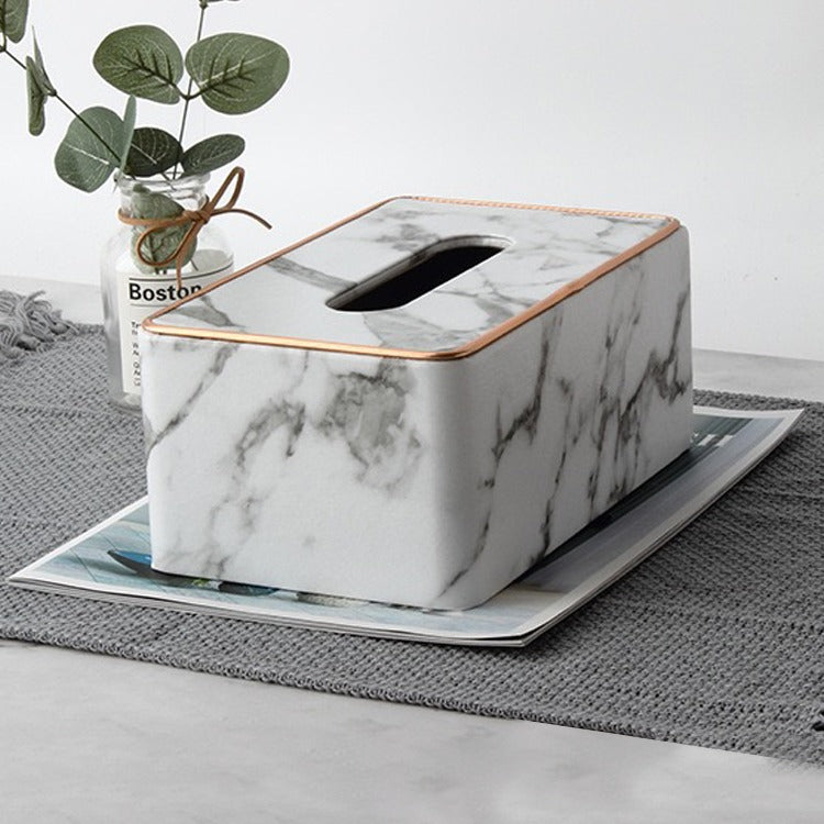 Rectangular Tissue Box Holder placed on the magazine next to a vase of flowers.