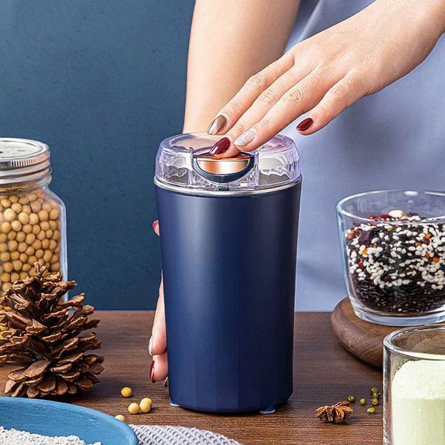 a lady holding Electric Coffee Grinder and Mixer