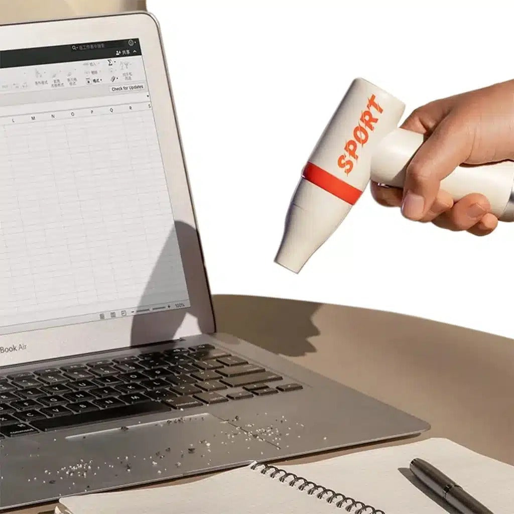 someone using One Touch High Speed Mini Fan to clean laptop