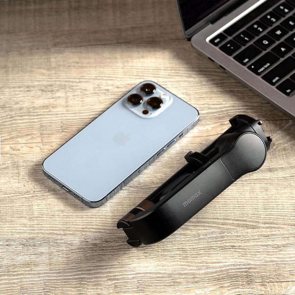 laptop and mobile phone is kept beside Momax One Click Rotation Selfie Stable